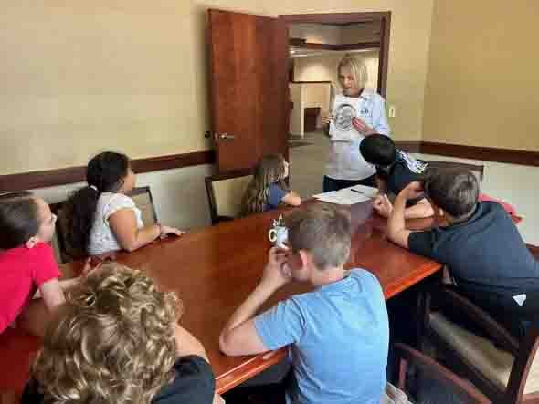 Central Penn employees give a financial presentation to a group of elementary school students.