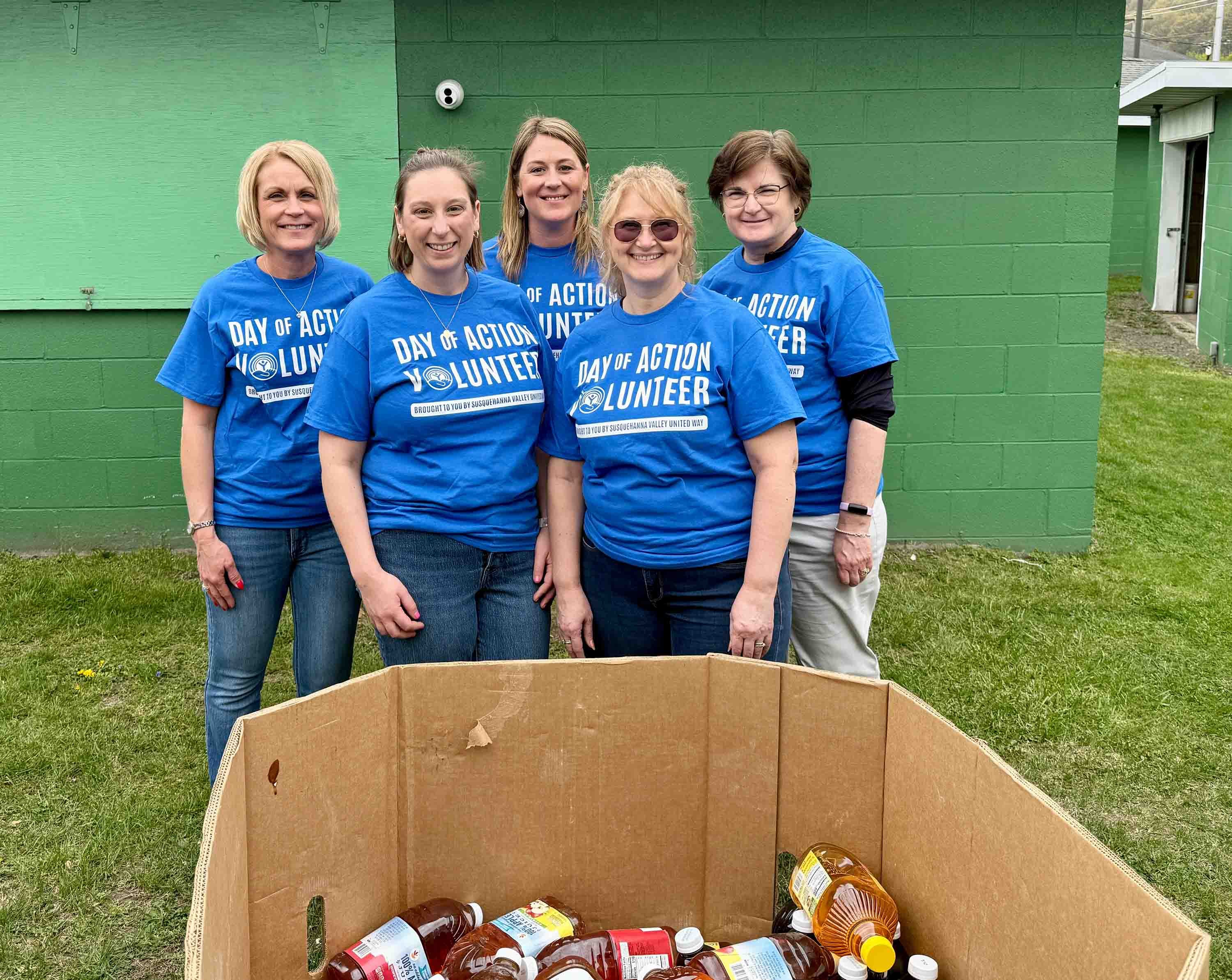 A group of Central Penn Bank volunteers stand together during a food drive. 