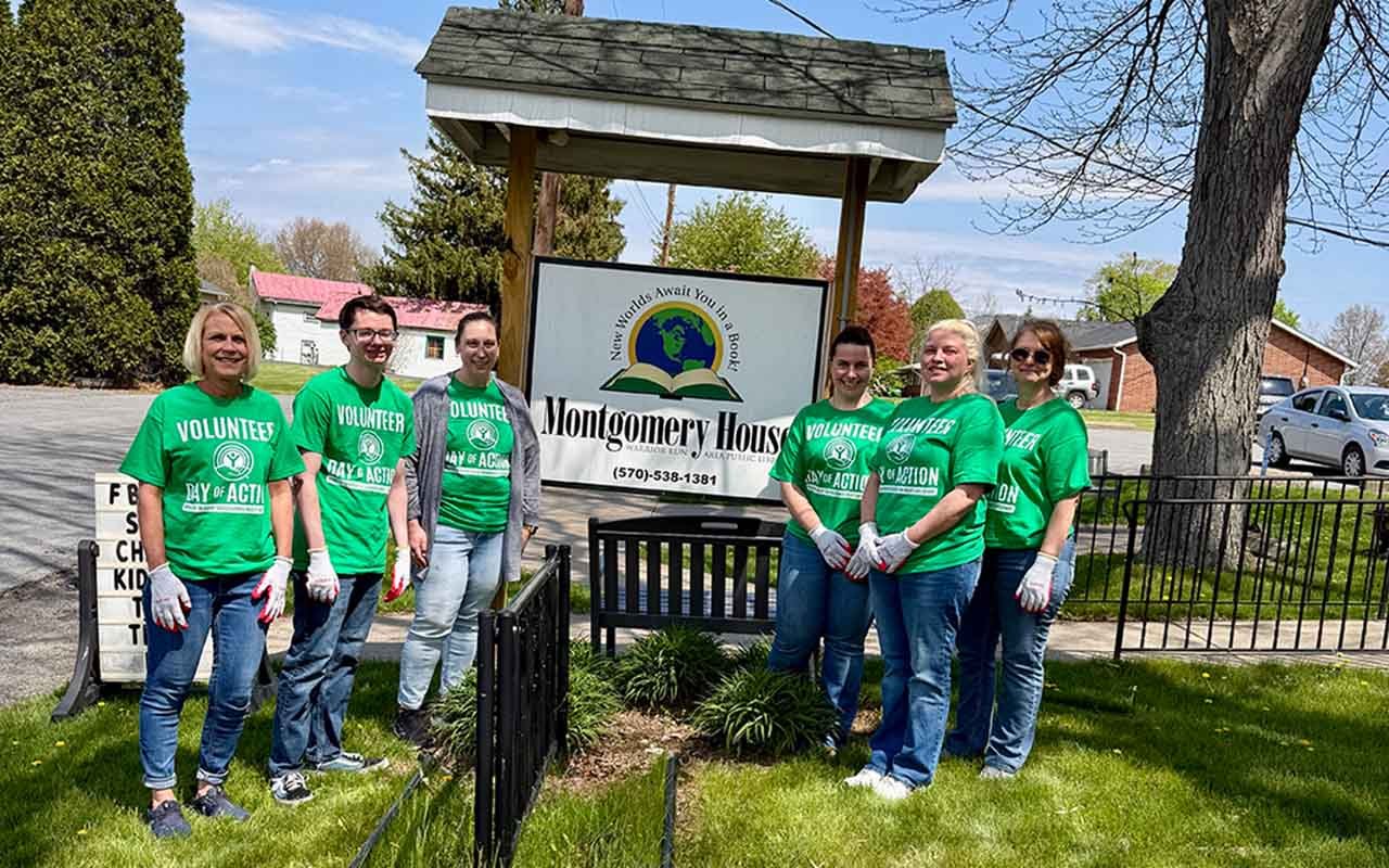 A group of Central Penn employees stand at the Montgomery House Library on the United Way Day of Action.