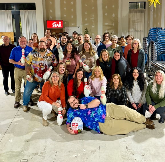 Photo of Central Penn Bank team smiling and holding bowling pins